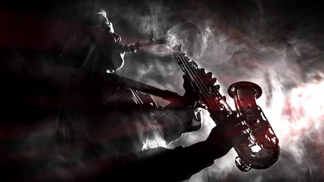Silhouette of a saxophone player in a smoky atmosphere, representing iconic non-guitar solos in music