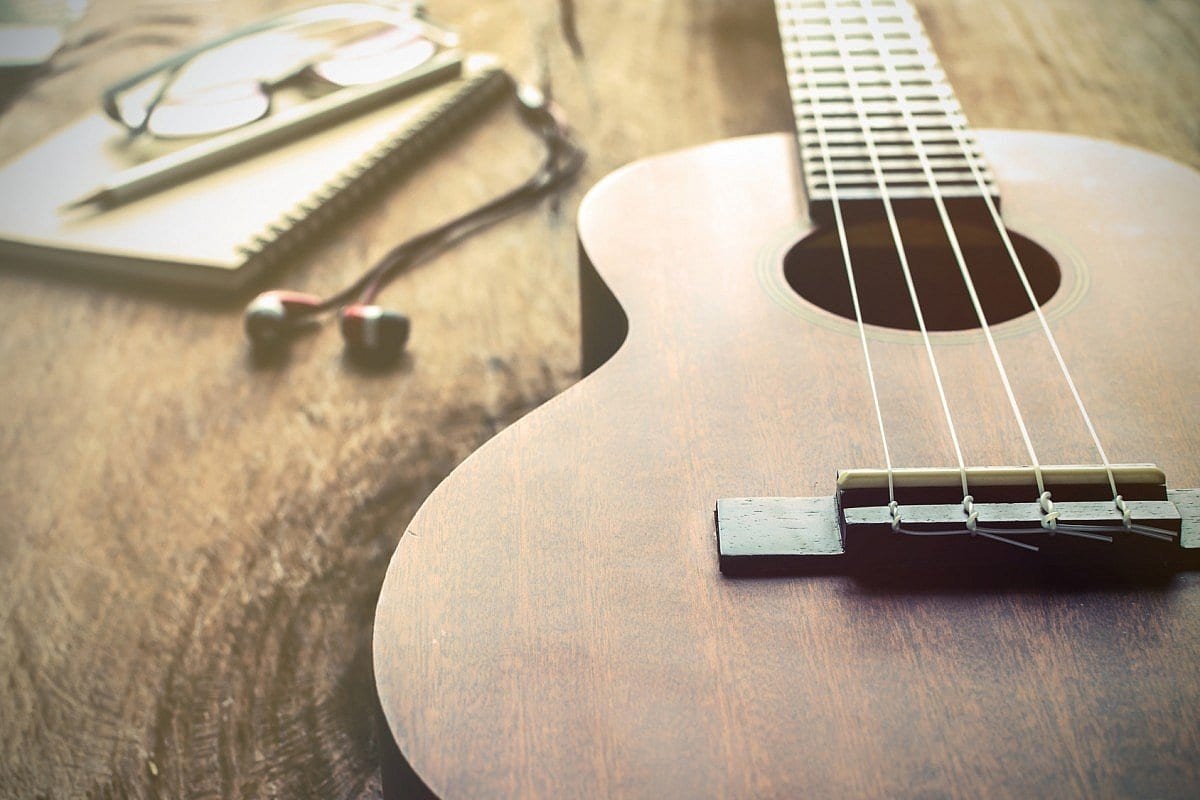 Wooden ukulele on a table representing a beginner’s guide to learning the ukulele