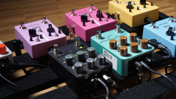 Colorful guitar pedals and power supply units connected on a pedalboard setup. What is a pedalboard power supply and why should you use one?