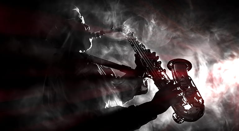 Silhouette of a saxophone player in a smoky atmosphere, representing iconic non-guitar solos in music