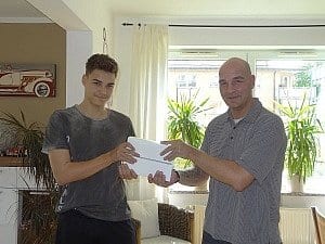 André T. – pictured here with his son – won an IPad with his review